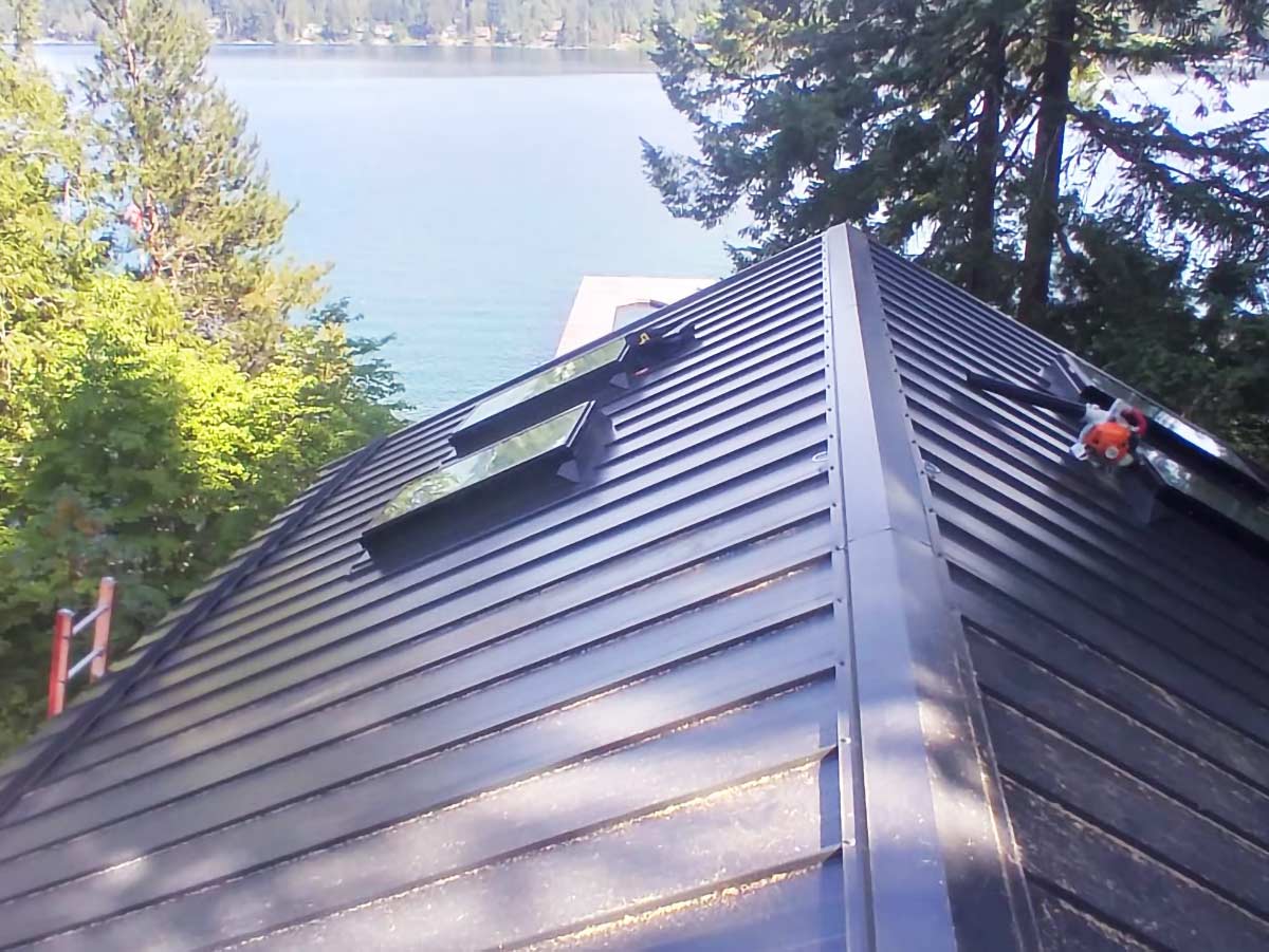 An image of a metal roof with the ocean in the background.